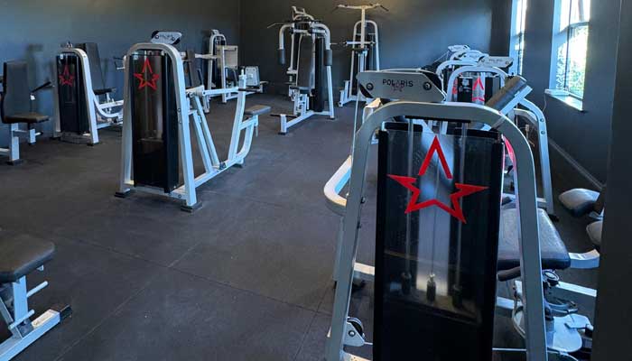 Modern gym at Tre Ysgawen Hall, Anglesey, North Wales, featuring advanced resistance machines for strength training