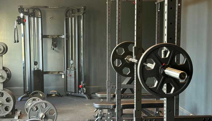 Well-equipped gym with a variety of loose weights at Tre Ysgawen Hall, Anglesey, North Wales