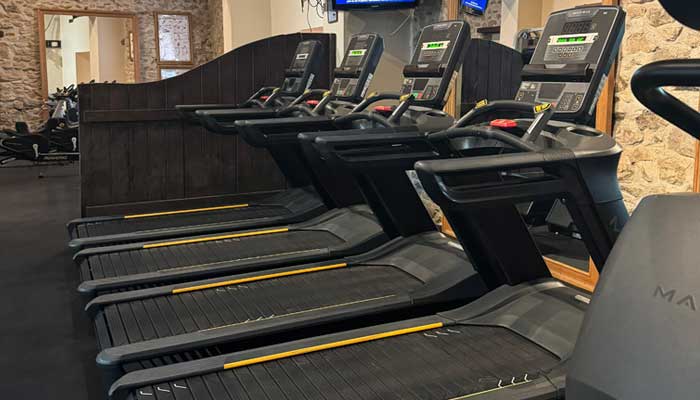 State-of-the-art gym at Tre Ysgawen Hall, Anglesey, North Wales, featuring advanced Matrix treadmills