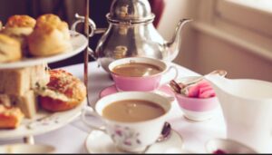 Afternoon tea set on an elegant table with fine china, scones, and pastries at Tre Ysgawen Hall, Anglesey"