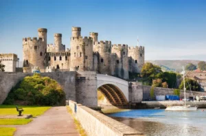 Conwy Castle and medieval town walls overlooking river and harbour in North Wales