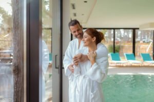 Couple in spa robes relaxing beside the indoor pool at Tresgawen Hall Spa in Cornwall