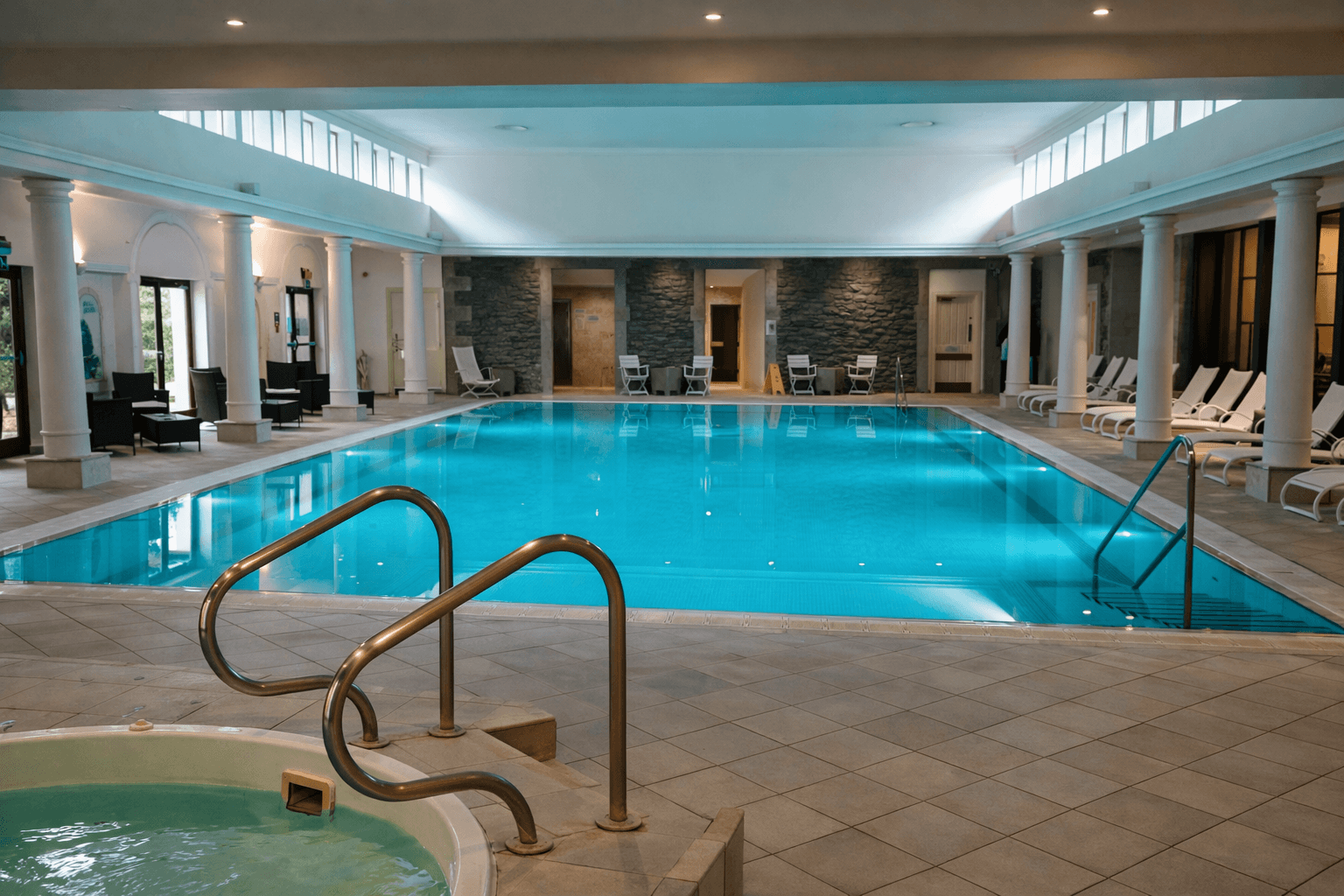 aIndoor swimming pool and spa relaxation area at Tresgawen Hall Spa in Anglesey