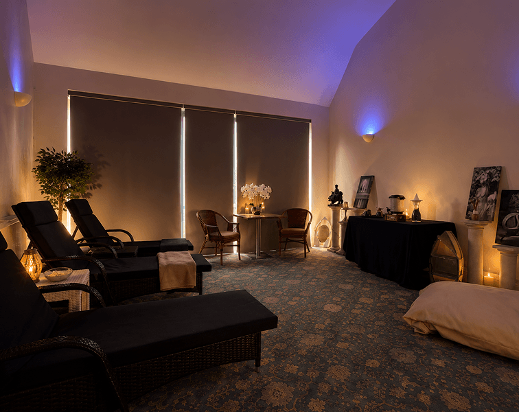Peaceful relaxation room at Tre-Ysgawen Hall Hotel & Spa in Anglesey featuring comfortable loungers, ambient lighting and a tranquil wellness atmosphere