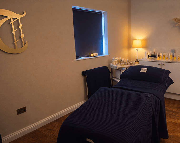 Luxury spa treatment room at Tre-Ysgawen Hall Hotel & Spa in Anglesey featuring a comfortable massage bed and professional skincare products